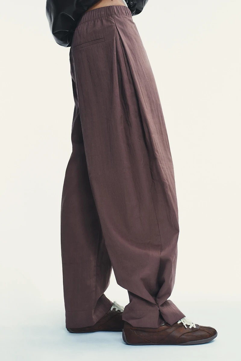 NYLON PANTS WITH BUTTON HEM