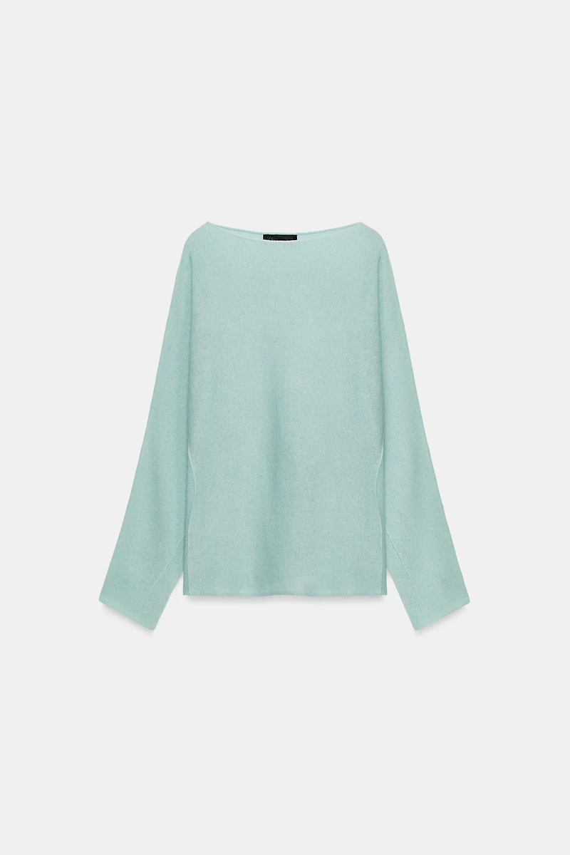 PULL EN MAILLE AVEC OUVERTURES SUR MANCHES