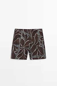 Tropical print swimming trunks