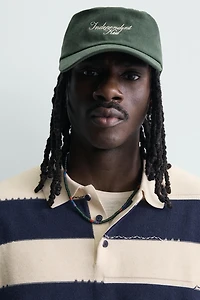 IRREGULAR STRIPED KNIT POLO SHIRT