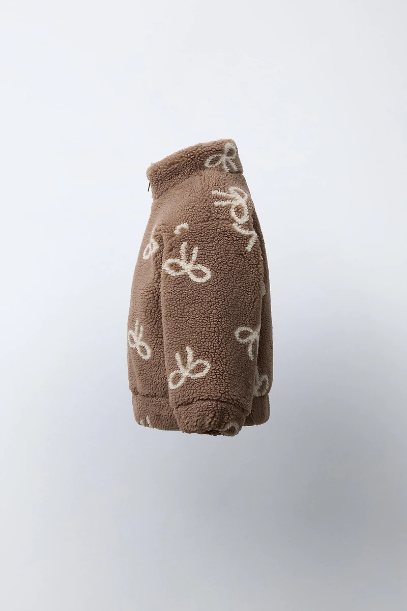 FAUX SHEARLING JACKET WITH BOW PRINT