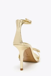 METALLIC EFFECT BOW HEELED SANDALS
