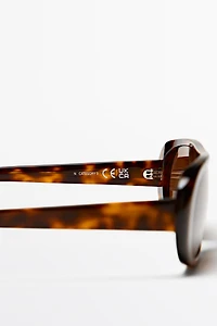Oval tortoiseshell-effect sunglasses