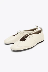 BALLERINES EN CUIR AVEC SURPIQÛRES