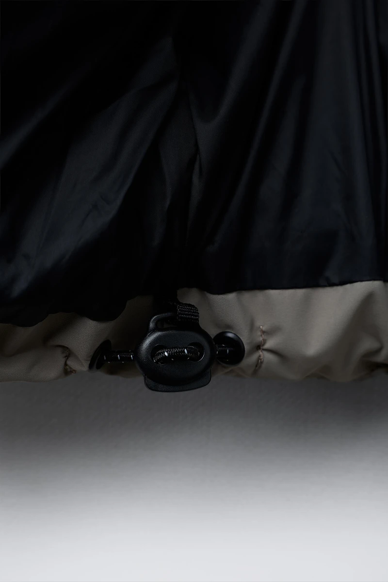 MANTEAU MATELASSÉ ZIPS DÉPERLANT