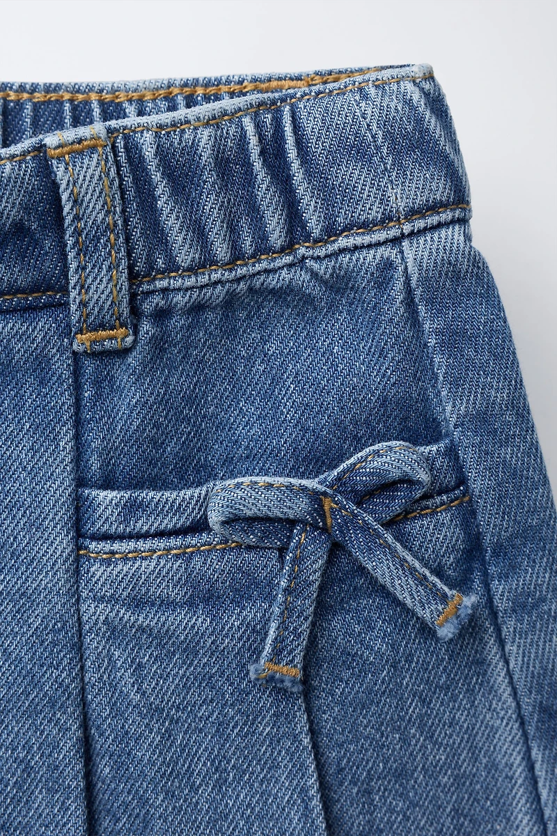 PLEATED DENIM SKIRT WITH BOWS