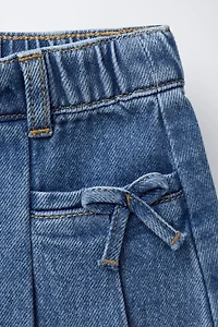 PLEATED DENIM SKIRT WITH BOWS