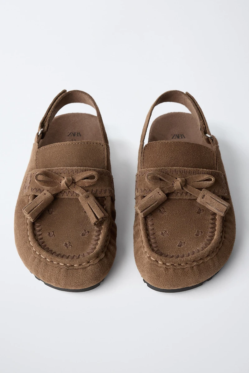 LEATHER CLOGS WITH TASSELS
