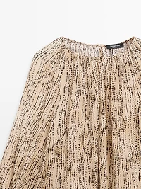 Semi-sheer draped blouse