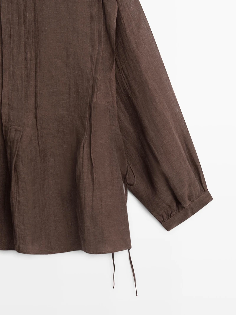 Flowing oversize linen blouse with ruffles