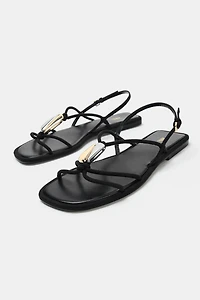 FLAT SANDALS WITH METALLIC APPLIQUÉ