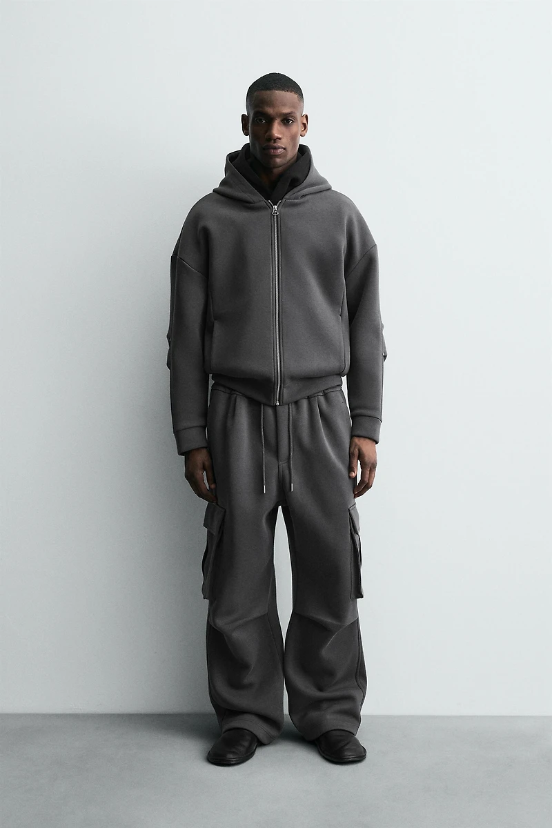 NEOPRENE EFFECT CARGO PANTS WITH PLEATS