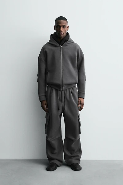 NEOPRENE EFFECT CARGO PANTS WITH PLEATS