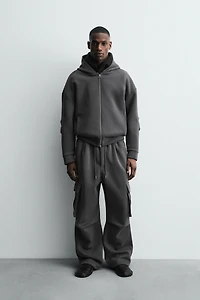 NEOPRENE EFFECT CARGO PANTS WITH PLEATS