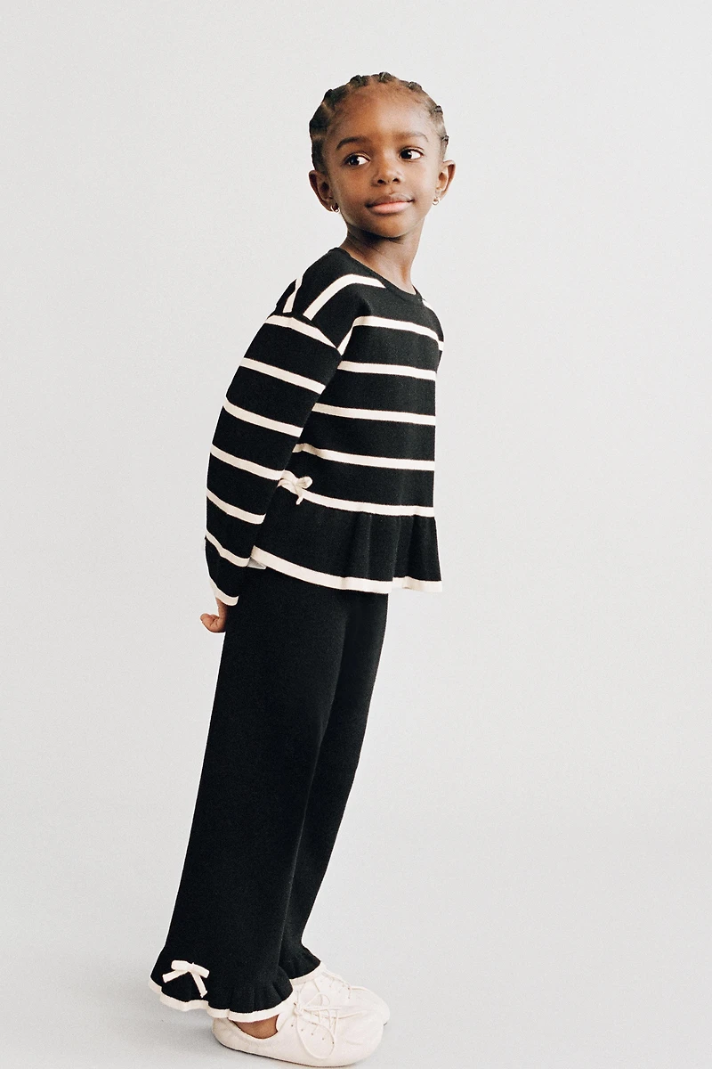 FLARED KNIT PANTS WITH BOWS AND RUFFLE