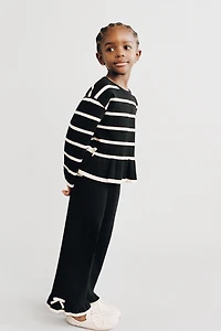 FLARED KNIT PANTS WITH BOWS AND RUFFLE