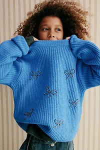 PULL EN MAILLE AVEC ORNEMENTS FANTAISIE LACETS BRILLANTS