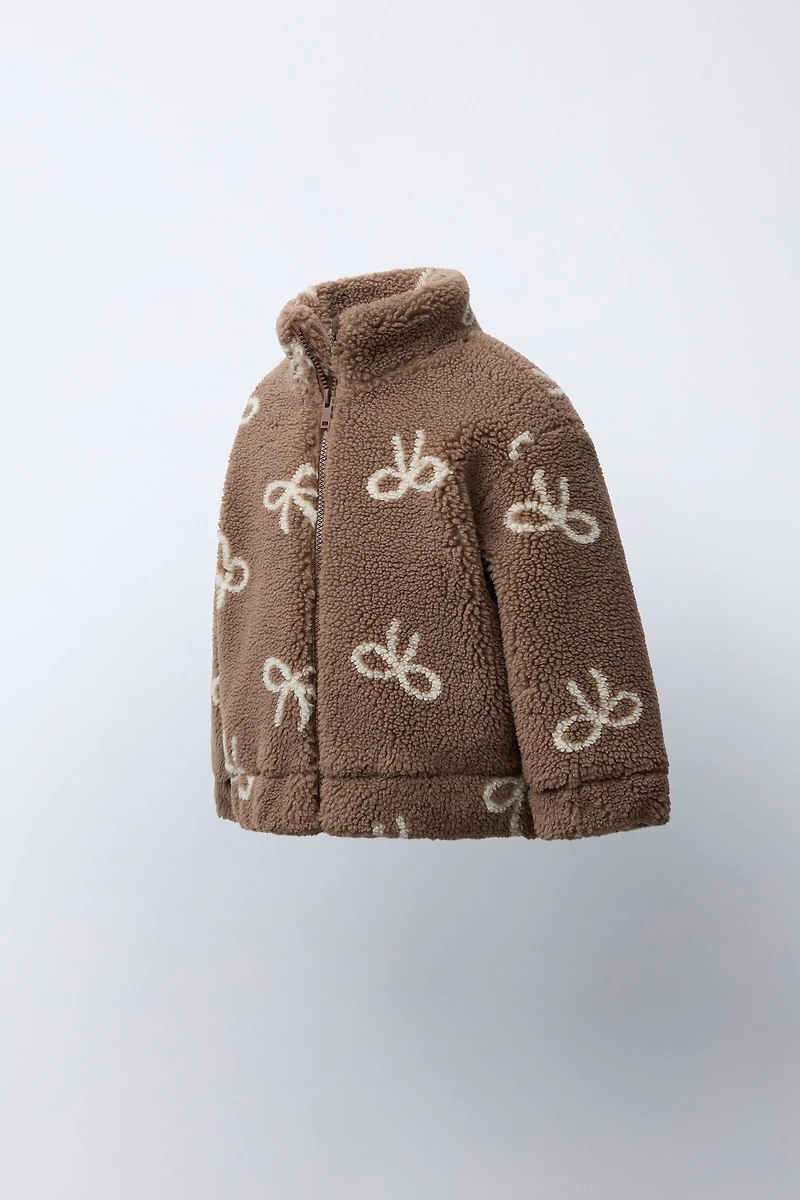 FAUX SHEARLING JACKET WITH BOW PRINT