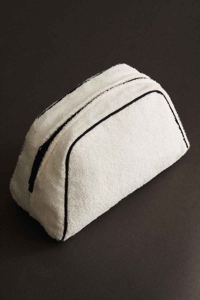 TERRY CLOTH TOILETRY BAG WITH PIPING DETAIL