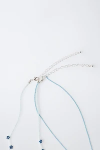 LOT DE DEUX COLLIERS FANTAISIE PAPILLON ET FLEURS