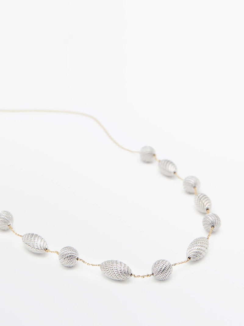Necklace with textured oval pieces