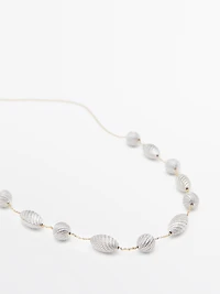 Necklace with textured oval pieces