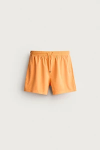 WASHED EFFECT LONG SWIM TRUNKS