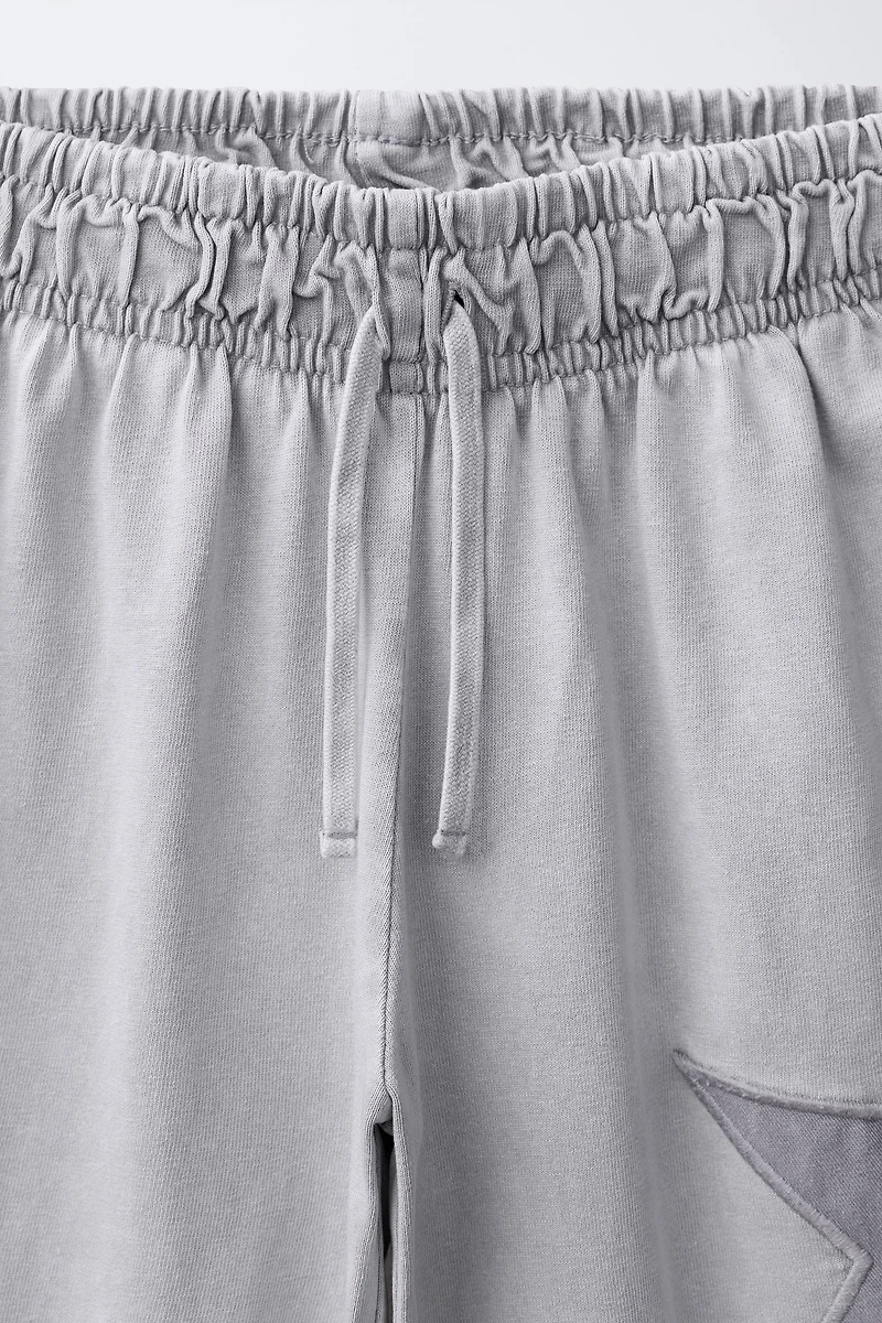 PANTALON LARGE EFFET DÉLAVÉ ÉTOILES