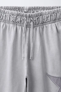 PANTALON LARGE EFFET DÉLAVÉ ÉTOILES