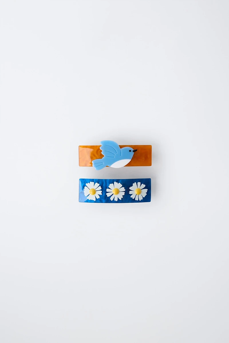 LOT DE DEUX BARRETTES À FLEURS ET OISEAU