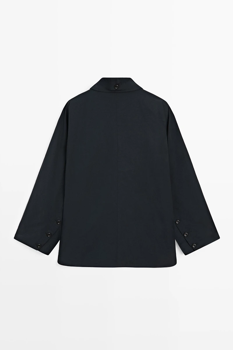 Jacket with buttoned collar strap