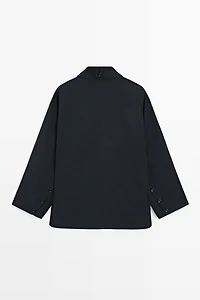 Jacket with buttoned collar strap