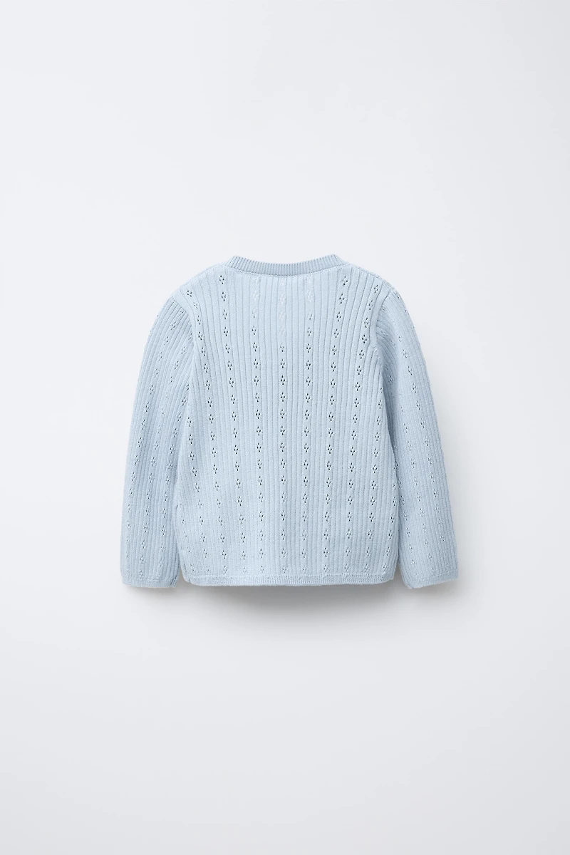 GILET EN MAILLE CROISÉ AJOURÉ