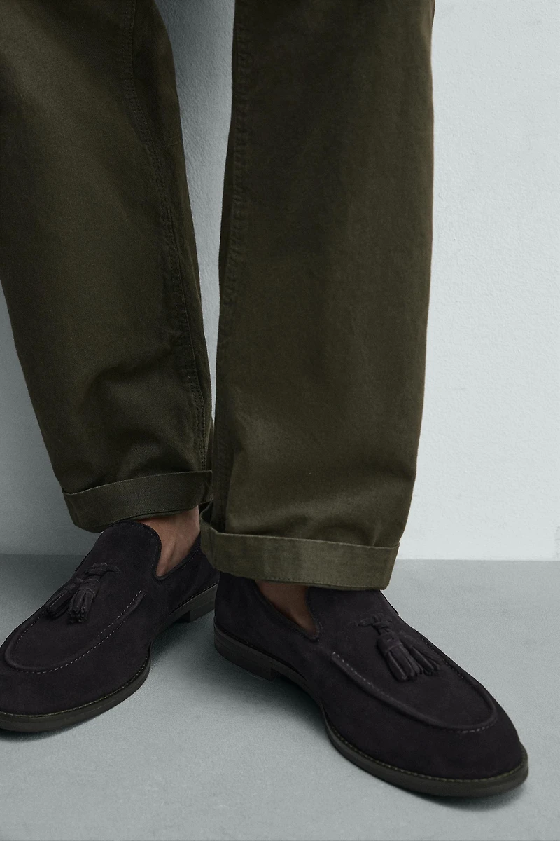MOCASSINS EN CUIR À POMPONS