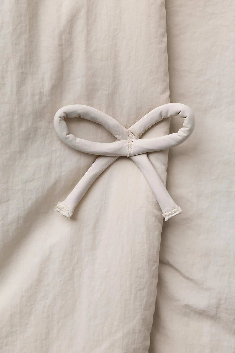WATER REPELLENT PUFFER COAT WITH BOWS