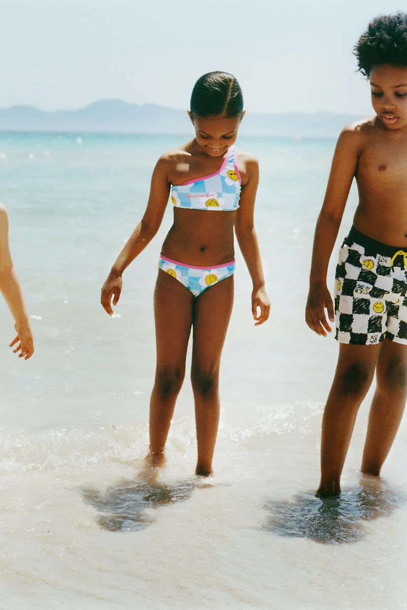 6-14 ANS/ SHORT DE BAIN DAMIER SMILEYWORLD ®
