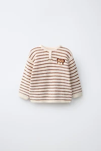 PULL EN MAILLE AVEC PIÈCE LION