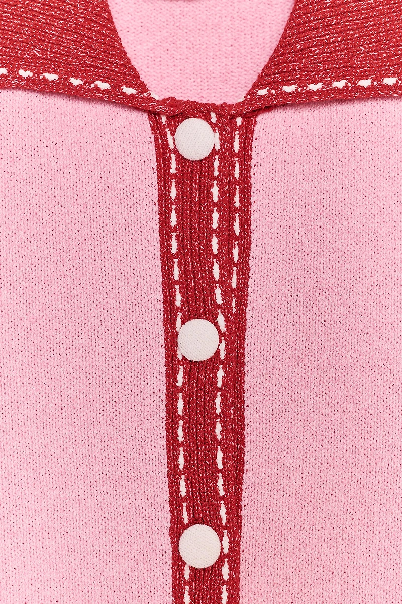 VESTE EN MAILLE SURPIQÛRES MANCHES COURTES