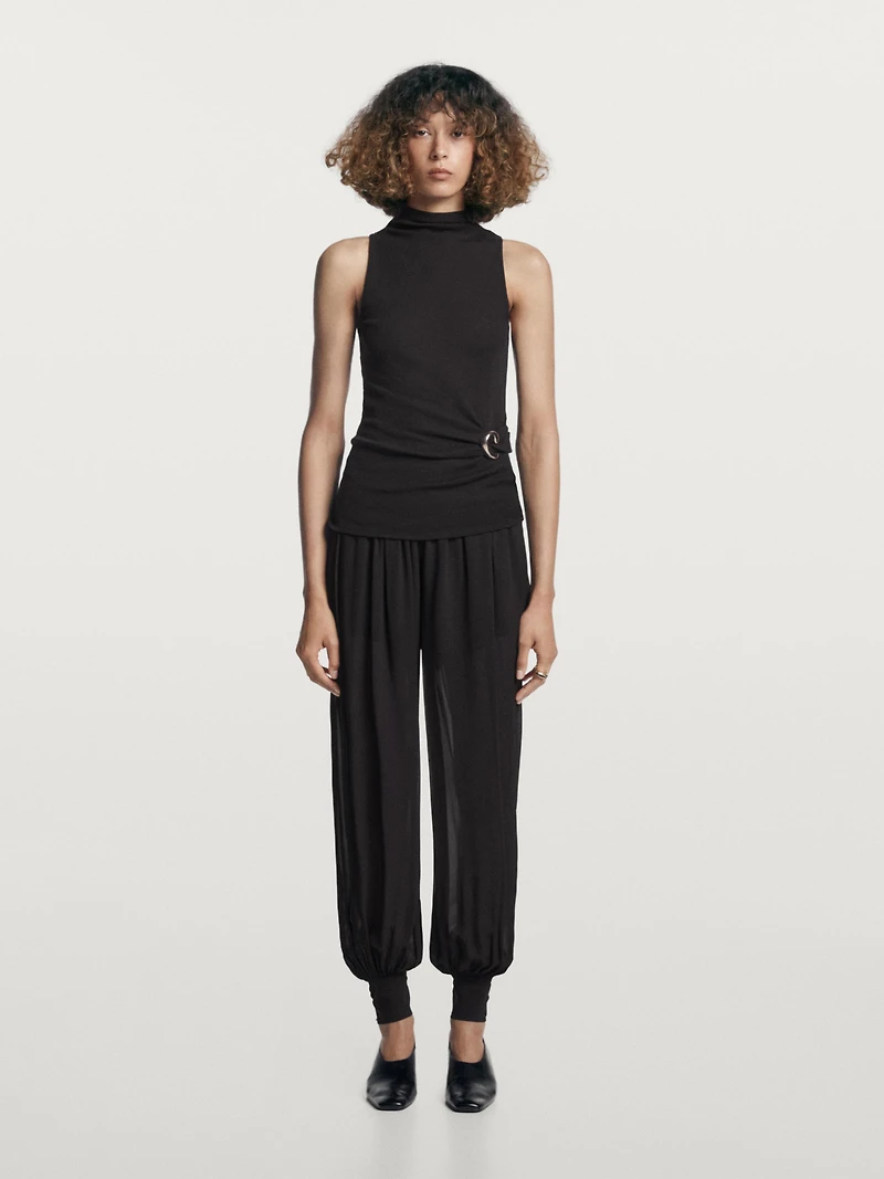 Funnel neck top with brooch detail