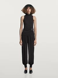 Funnel neck top with brooch detail