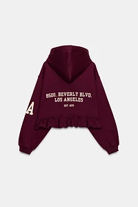 RUFFLED VARSITY SWEATSHIRT