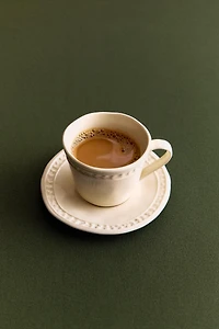 STONEWARE RAISED DESIGN COFFEE CUP AND SAUCER