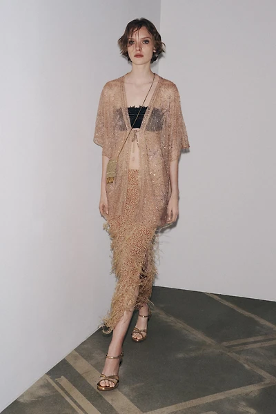 JUPE À PAILLETTES ET PLUMES