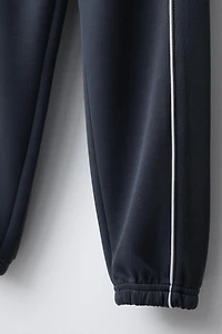 JOGGERS WITH CONTRASTING PIPING