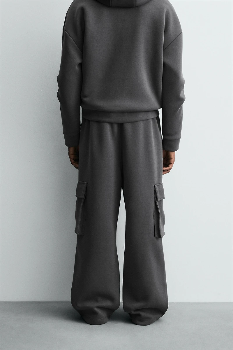 NEOPRENE EFFECT CARGO PANTS WITH PLEATS