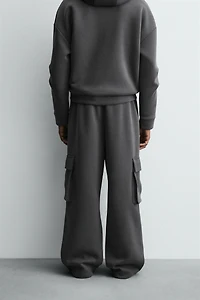 NEOPRENE EFFECT CARGO PANTS WITH PLEATS