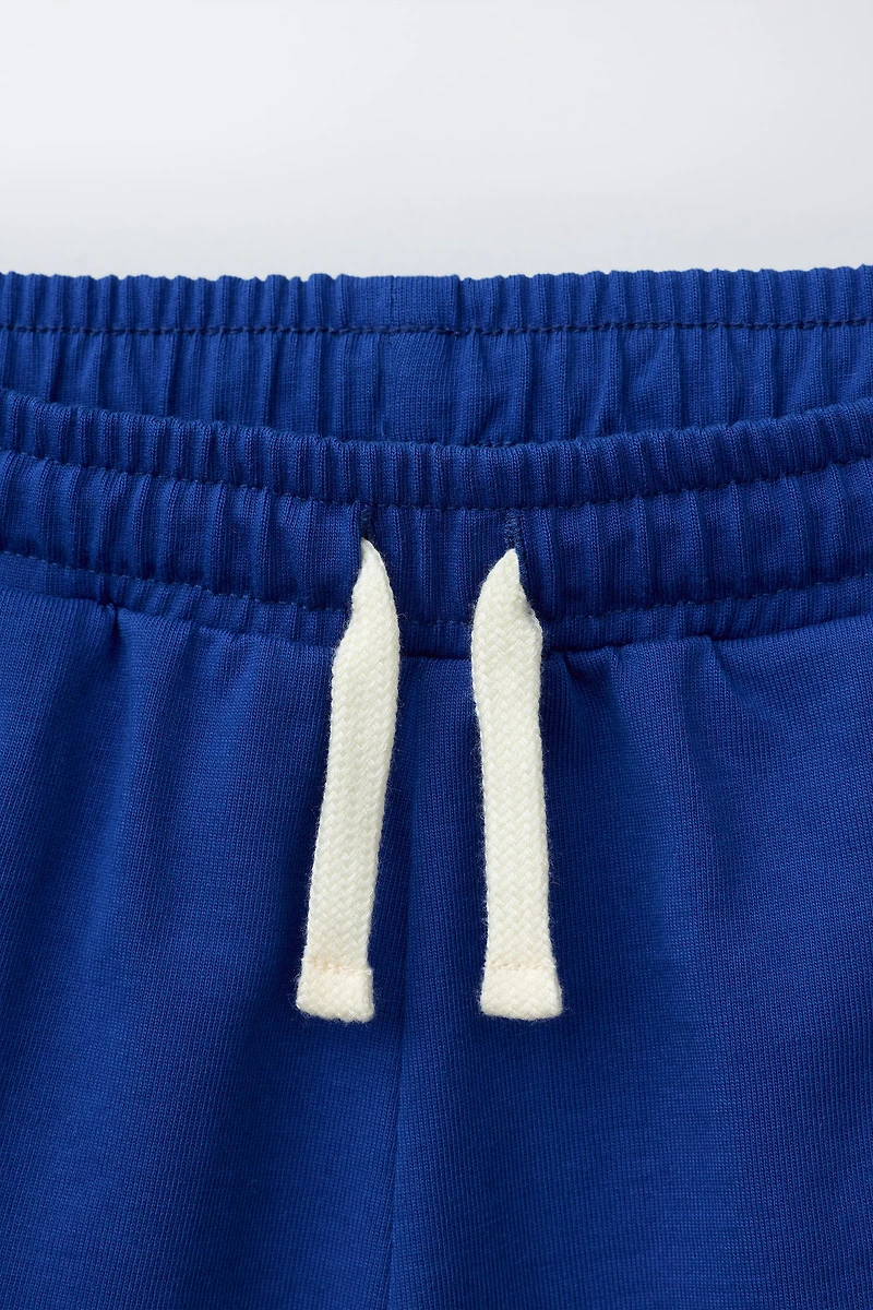 PLUSH SHORTS WITH CONTRAST PIPING