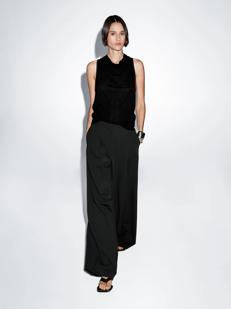 Sleeveless top with draped neckline