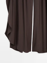 Wide-leg pleated trousers with side vents