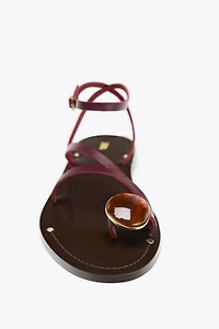 FLAT LEATHER SANDALS WITH DECORATIVE STRAPS